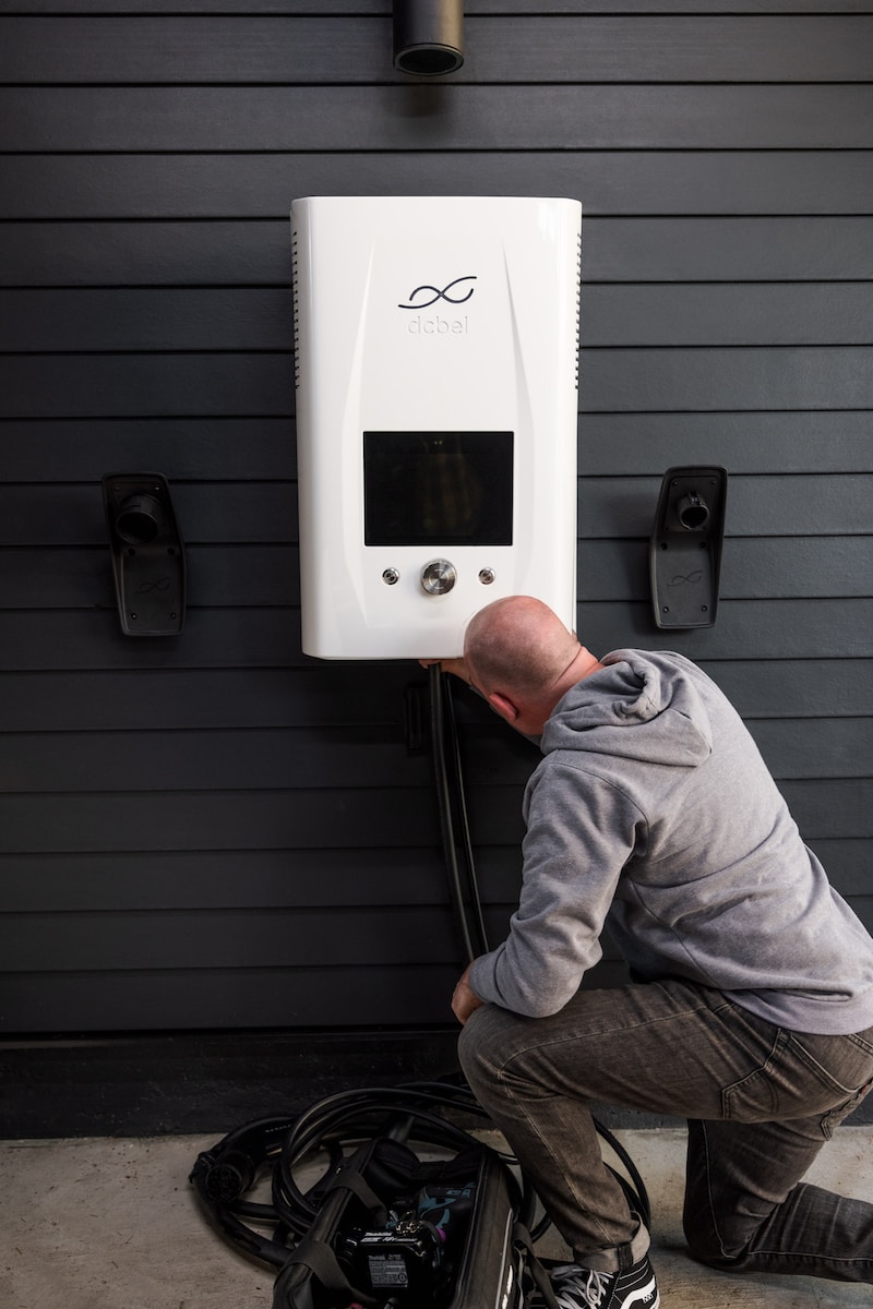 a man is fixing a water heater outside